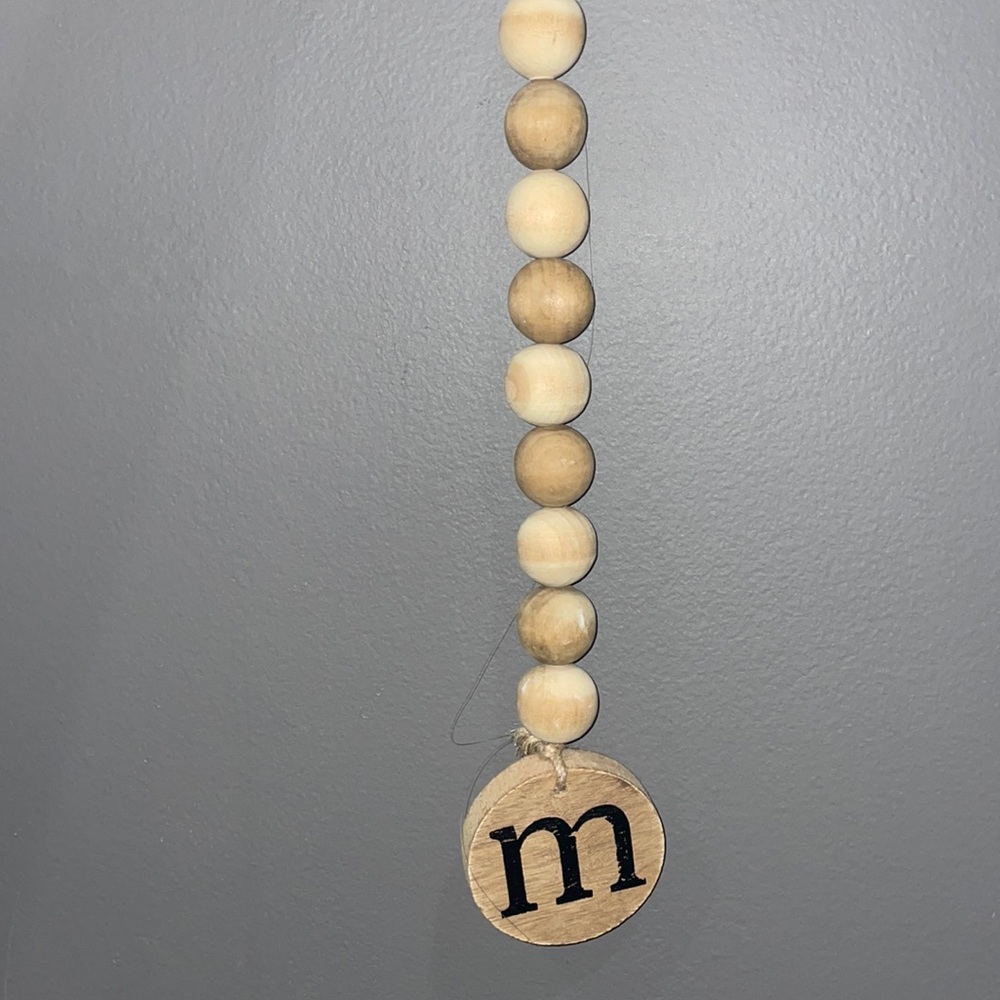 Wall hanging with the letter M.